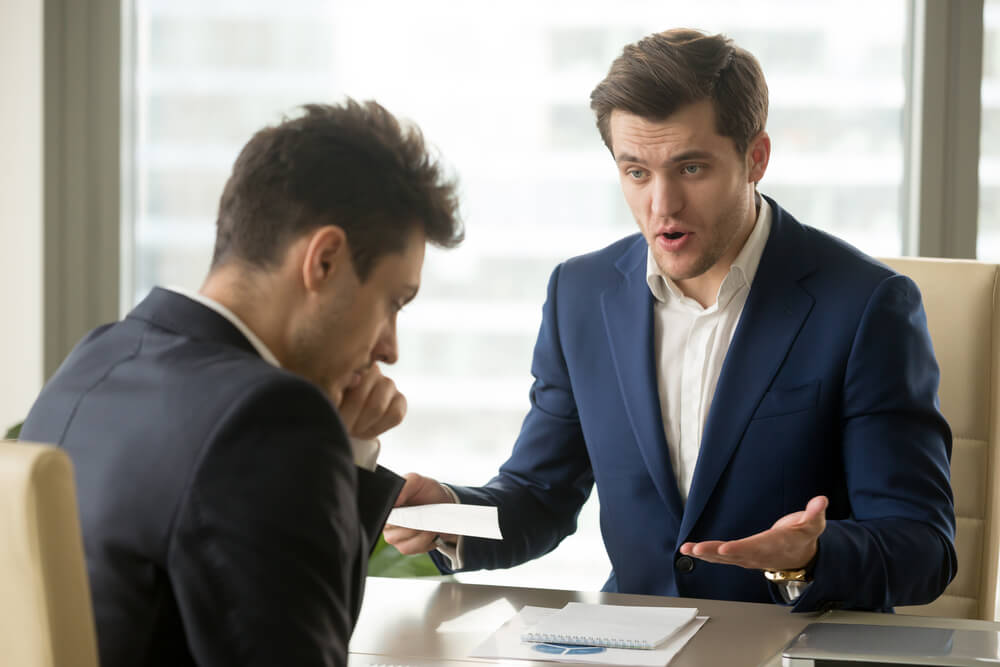 male employee getting scolded by boss
